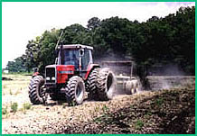 Description: tractor discing in sludge